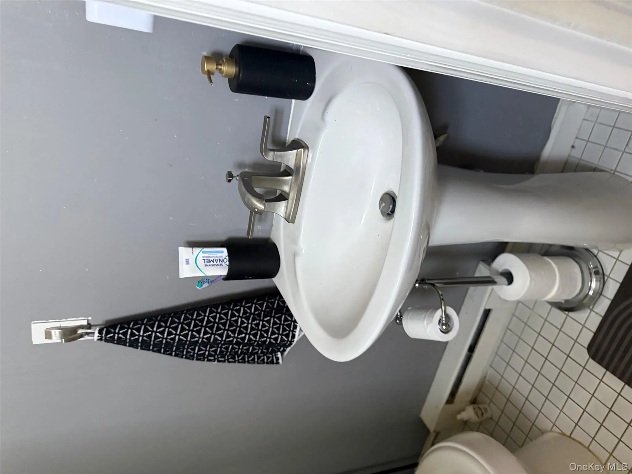 Bathroom featuring baseboard heating and light tile patterned flooring Bathroom featuring baseboard heating and light tile patterned flooring