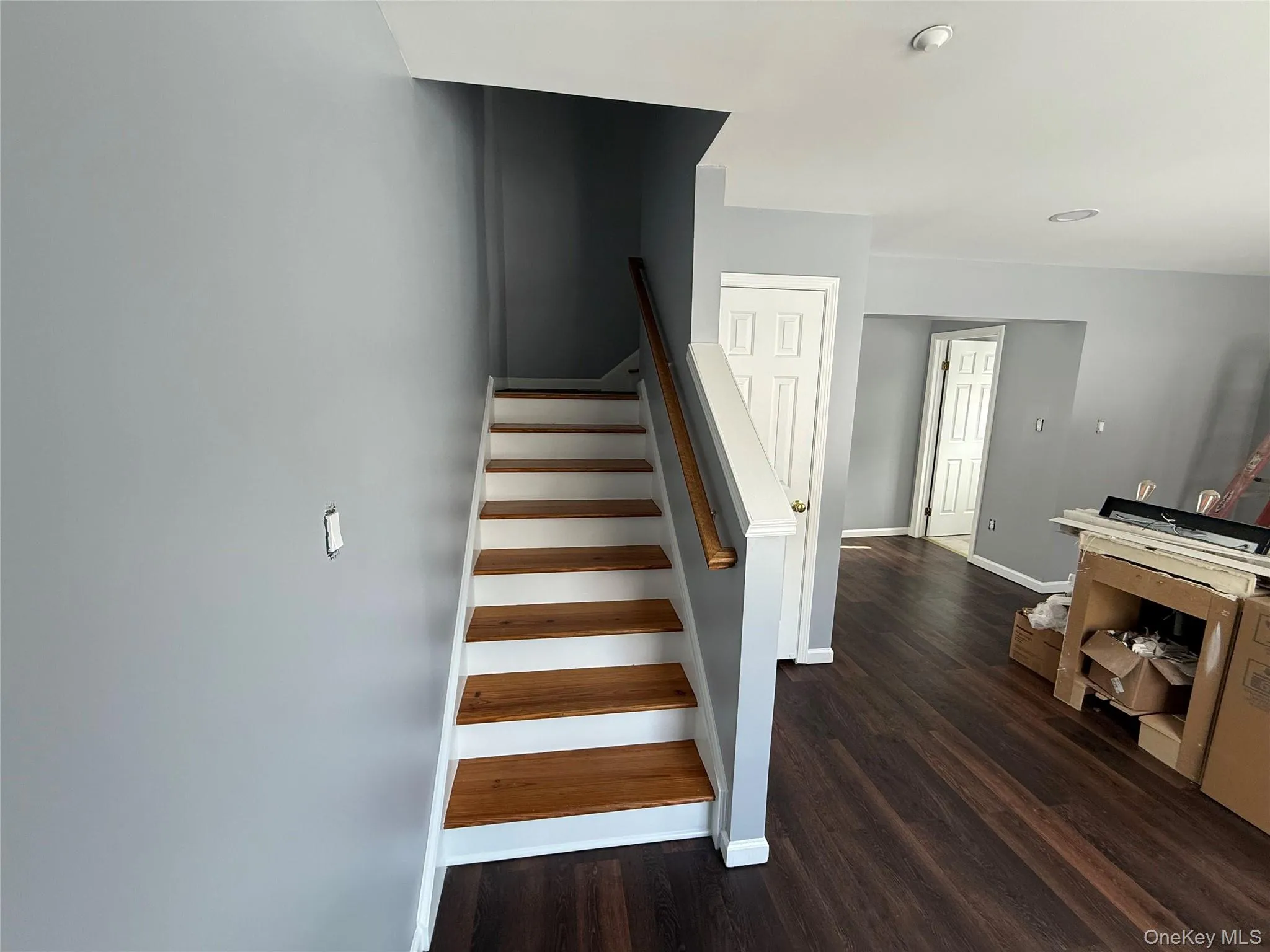 Stairway featuring baseboards and wood finished floors Stairway featuring baseboards and wood finished floors