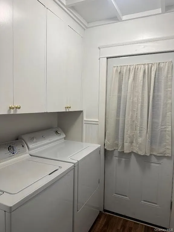 Laundry area with washer and clothes dryer and dark wood style floors Laundry area with washer and clothes dryer and dark wood style floors