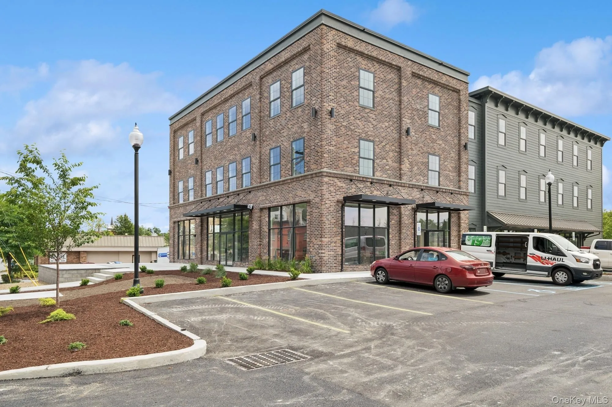 View of building exterior with uncovered parking View of building exterior with uncovered parking