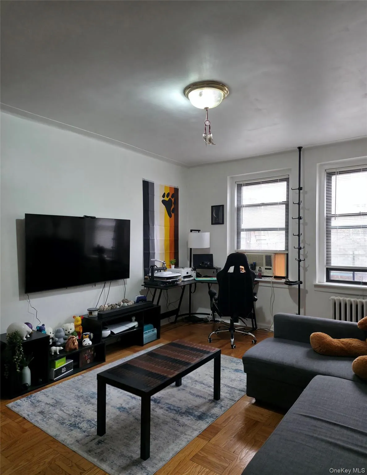 Living area featuring a desk and radiator heating unit Living area featuring a desk and radiator heating unit