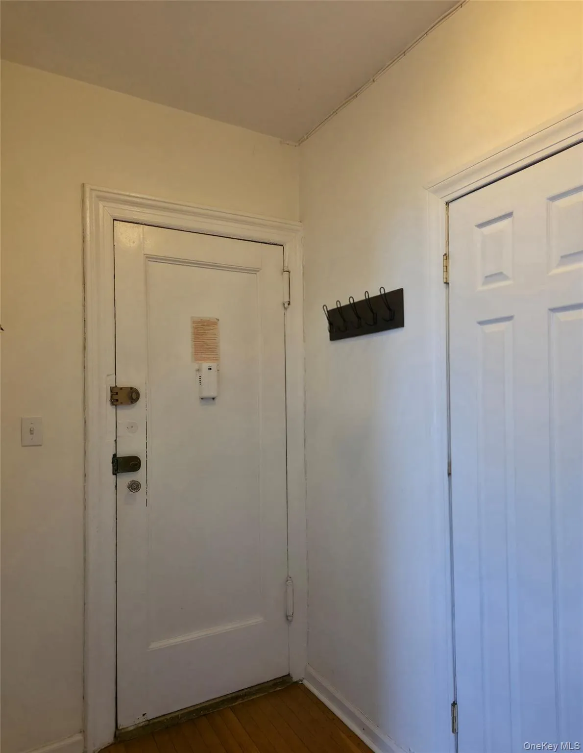 Doorway with hardwood / wood-style flooring and baseboards Doorway with hardwood / wood-style flooring and baseboards