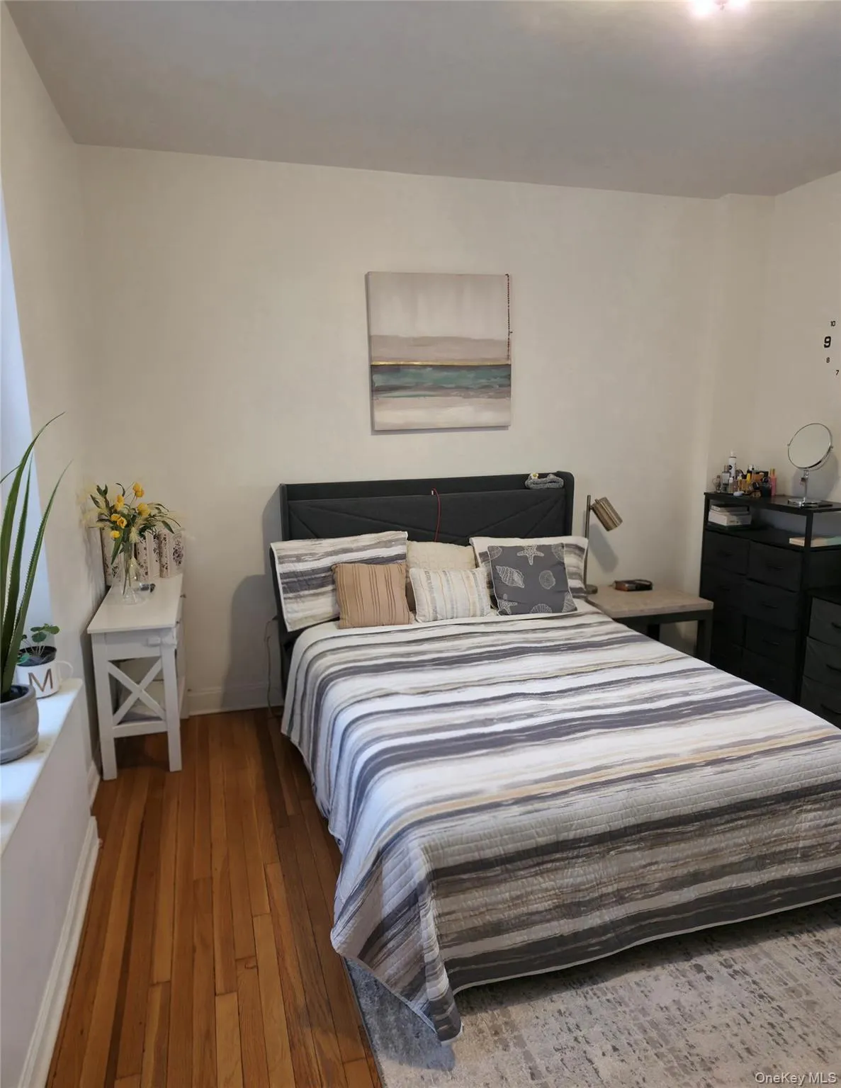 Bedroom featuring hardwood / wood-style flooring and baseboards Bedroom featuring hardwood / wood-style flooring and baseboards