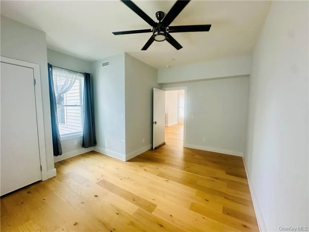 Unfurnished bedroom with ceiling fan and light hardwood / wood-style floors Unfurnished bedroom with ceiling fan and light hardwood / wood-style floors