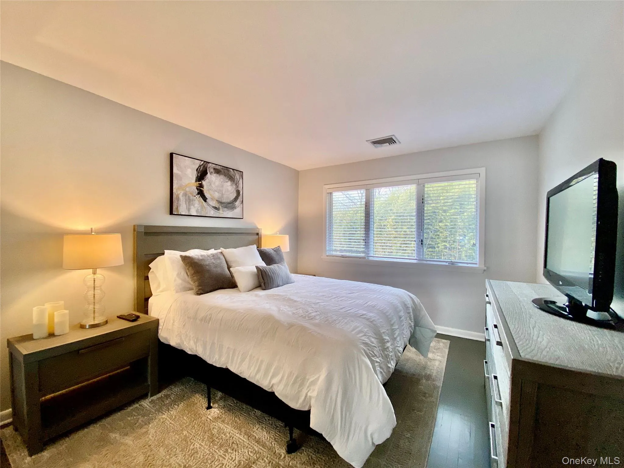 Bedroom with wood finished floors and baseboards Bedroom with wood finished floors and baseboards