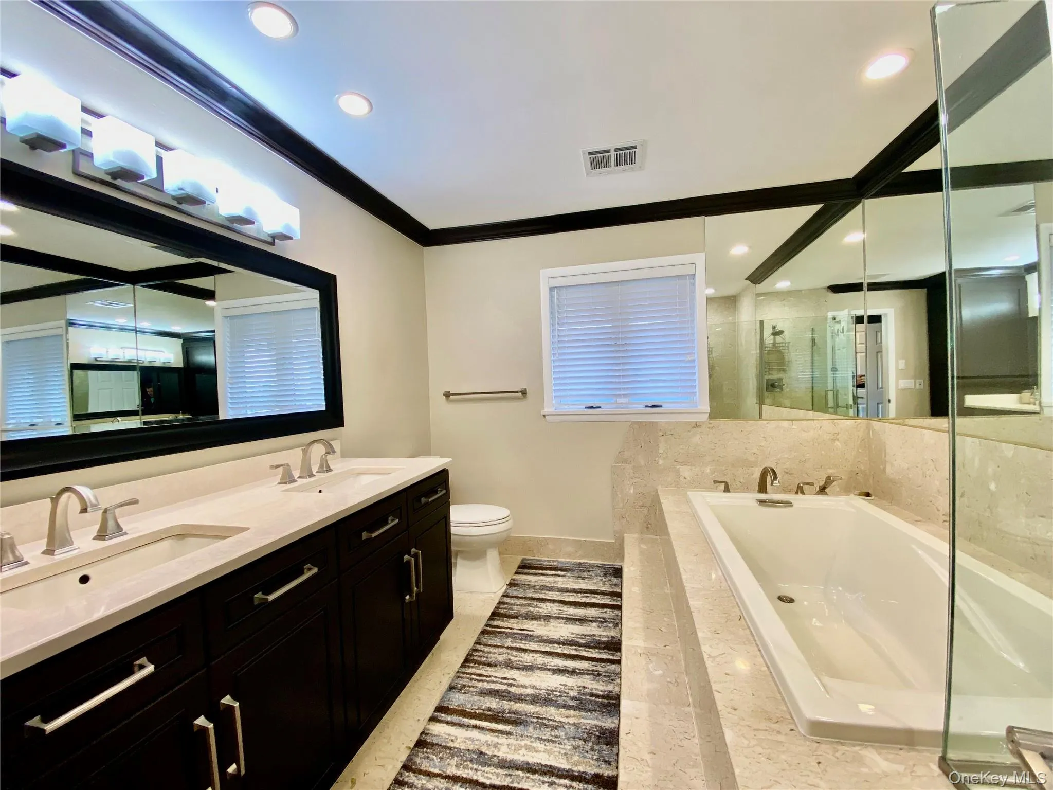 Primary Bathroom with a bath, double vanity, a stall shower, crown molding, and recessed lighting Primary Bathroom with a bath, double vanity, a stall shower, crown molding, and recessed lighting