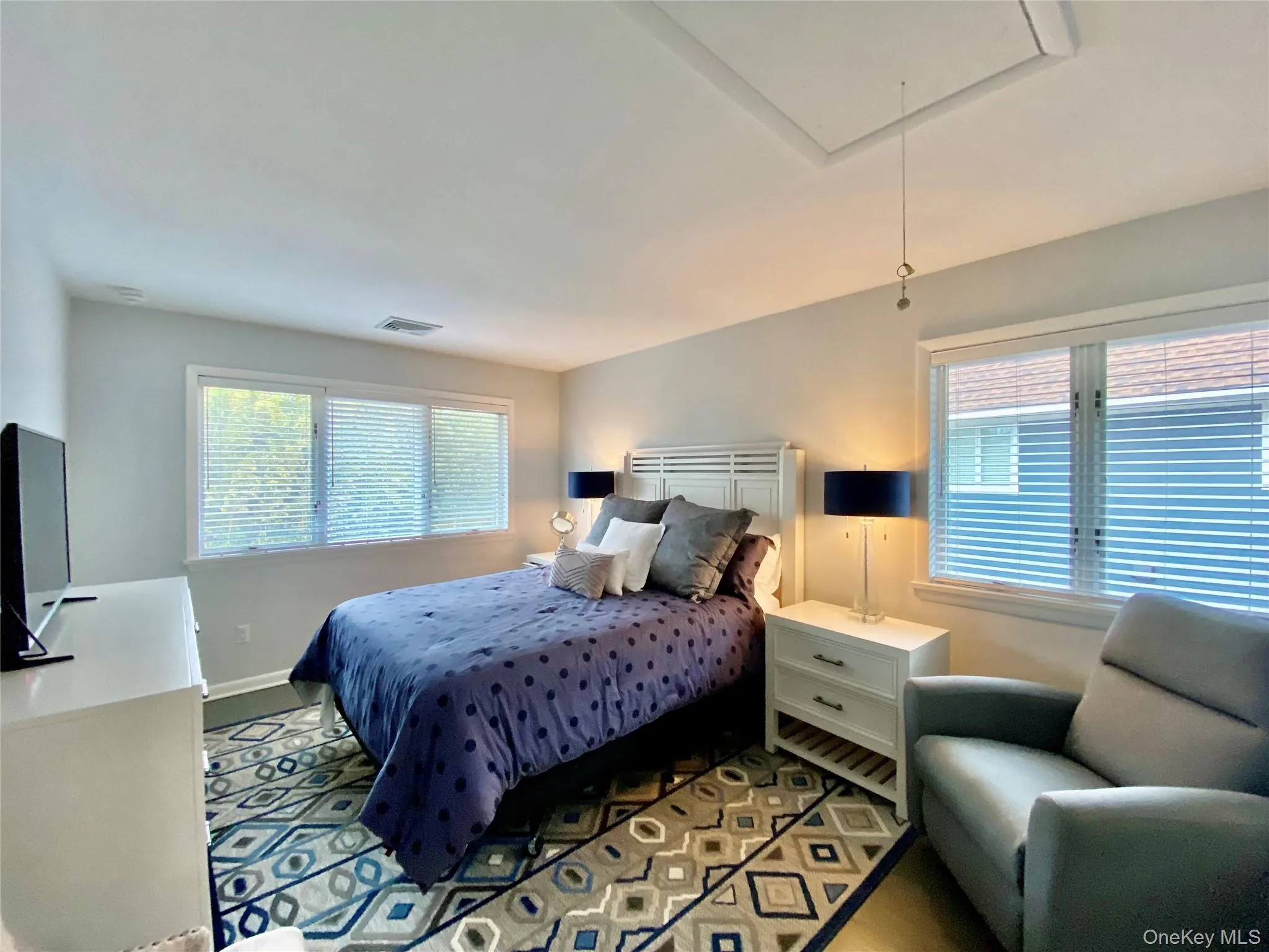 Bedroom with attic access and baseboards Bedroom with attic access and baseboards