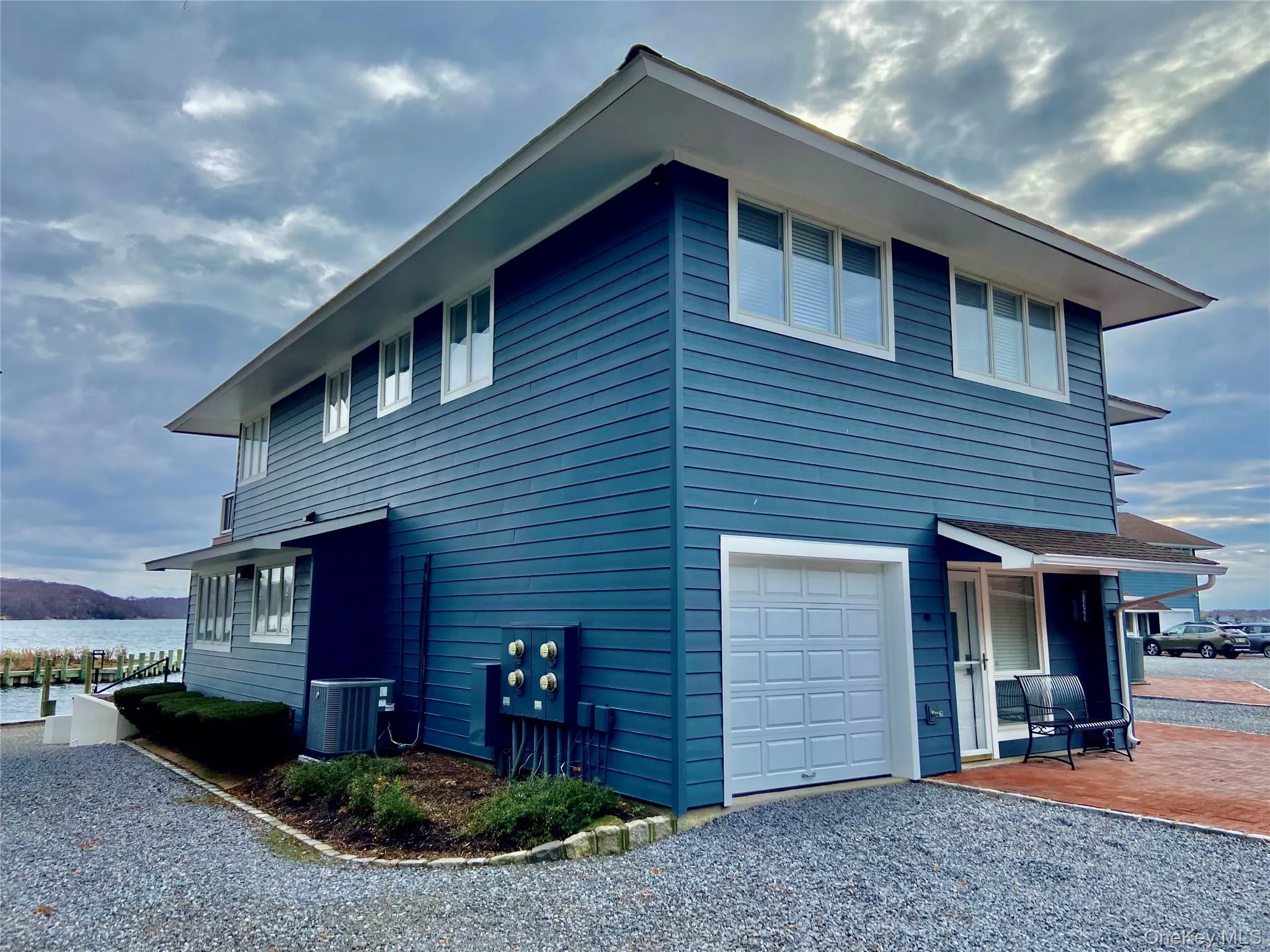 View of property exterior with a central AC unit and an attached garage View of property exterior with a central AC unit and an attached garage