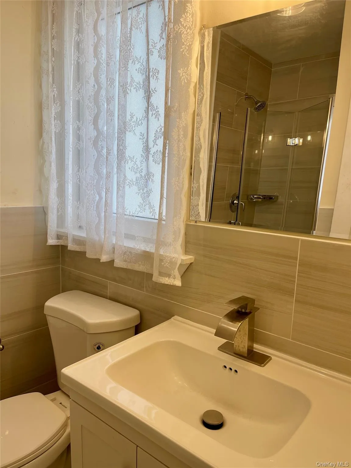 Full bathroom featuring a shower with shower curtain and vanity Full bathroom featuring a shower with shower curtain and vanity