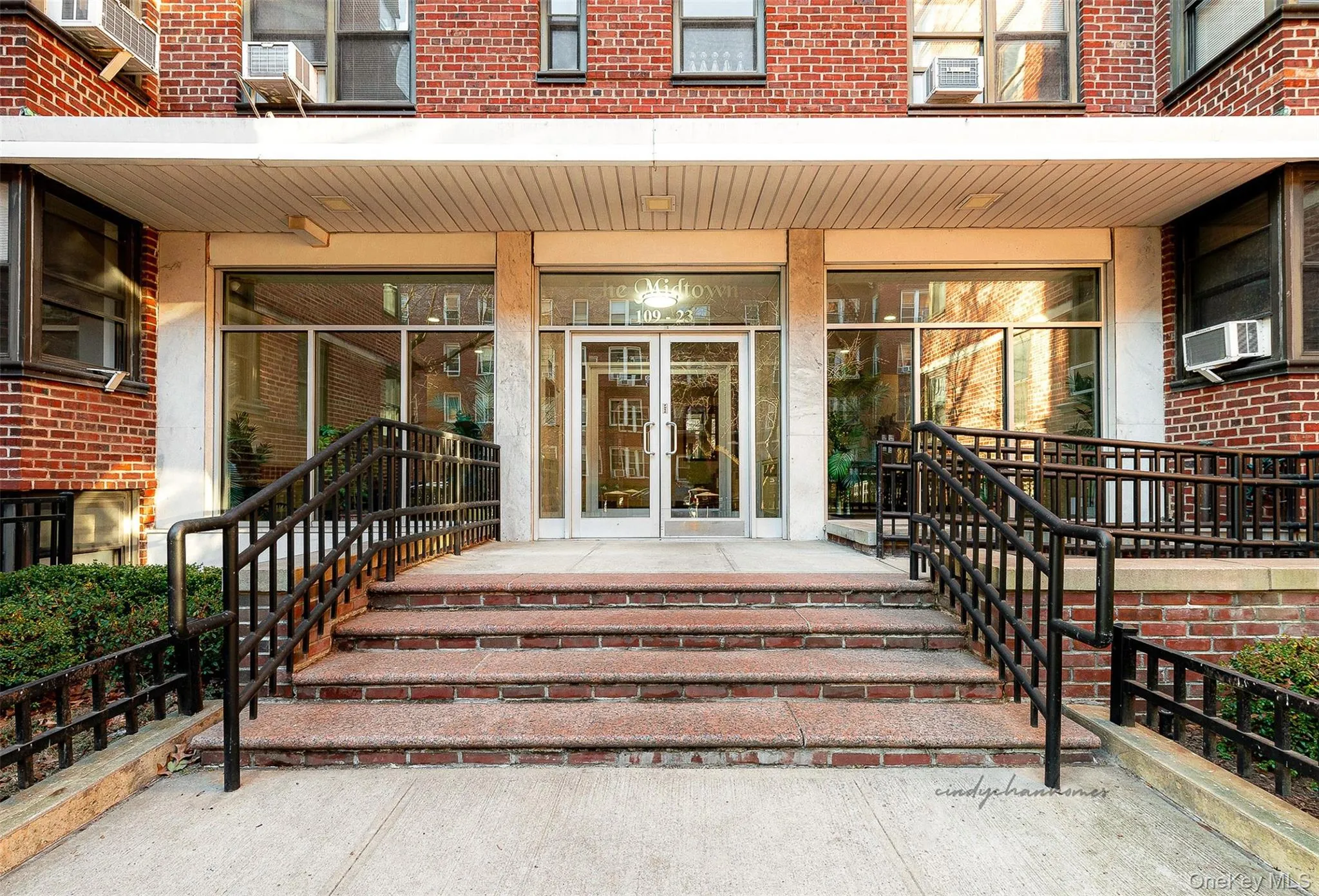 Entrance to property featuring brick siding, cooling unit, and french doors Entrance to property featuring brick siding, cooling unit, and french doors