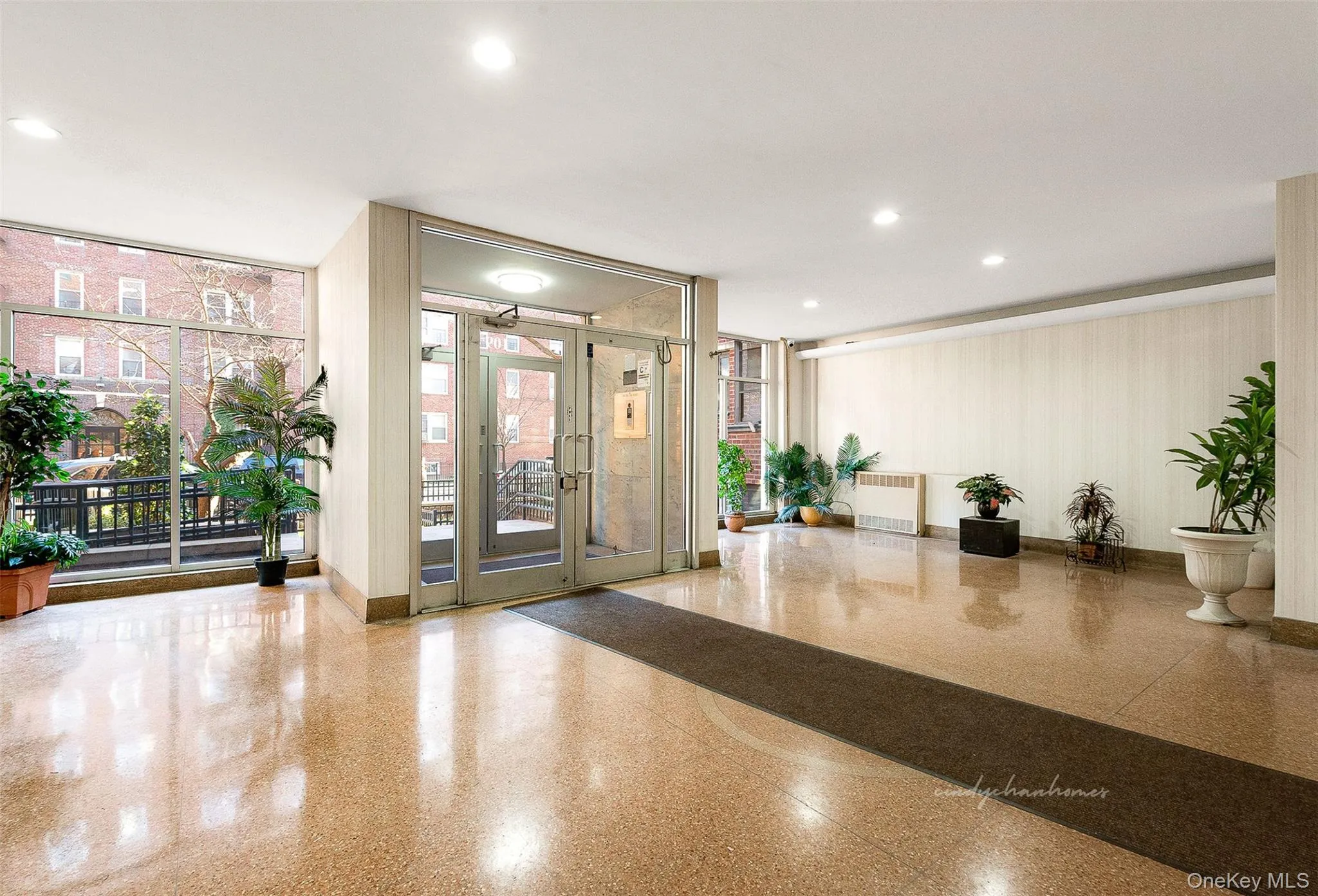Common area featuring recessed lighting and a wall of windows Common area featuring recessed lighting and a wall of windows