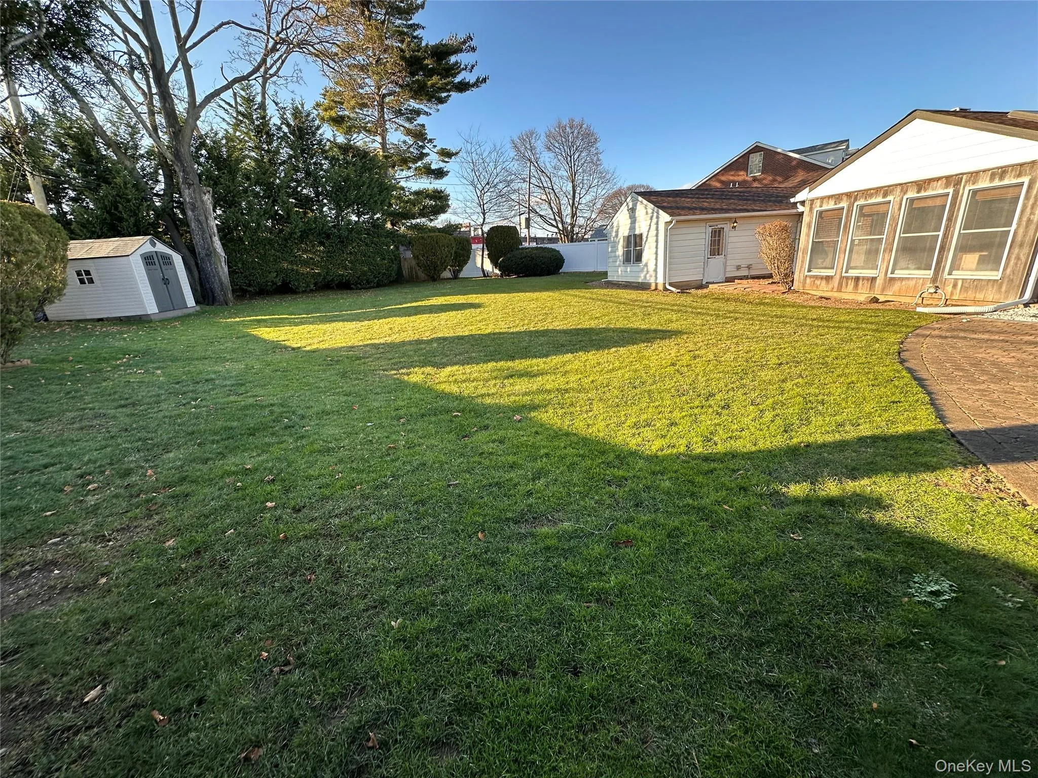 View of yard featuring a storage shed and a sunroom View of yard featuring a storage shed and a sunroom