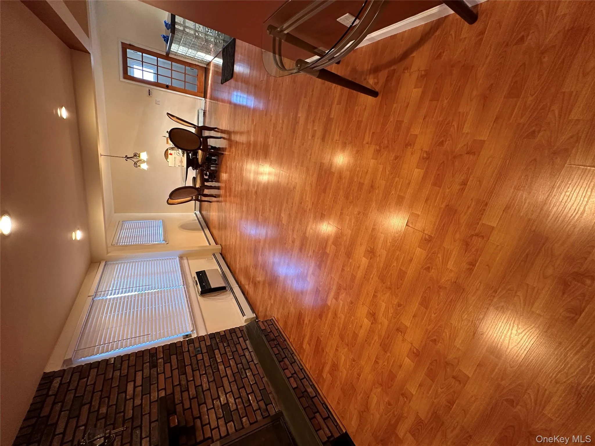 Dining area with light wood-style flooring, a baseboard heating unit, a wall mounted air conditioner, and recessed lighting Dining area with light wood-style flooring, a baseboard heating unit, a wall mounted air conditioner, and recessed lighting