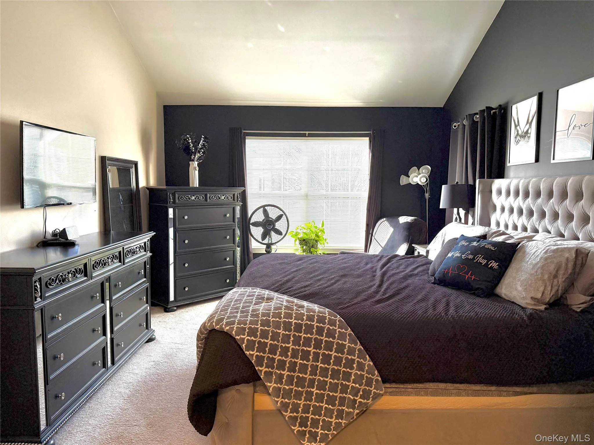 Bedroom featuring lofted ceiling and carpet flooring Bedroom featuring lofted ceiling and carpet flooring