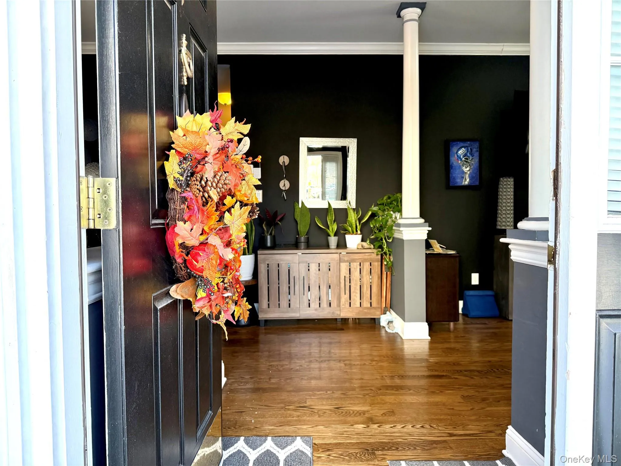 Foyer featuring crown molding and wood finished floors Foyer featuring crown molding and wood finished floors