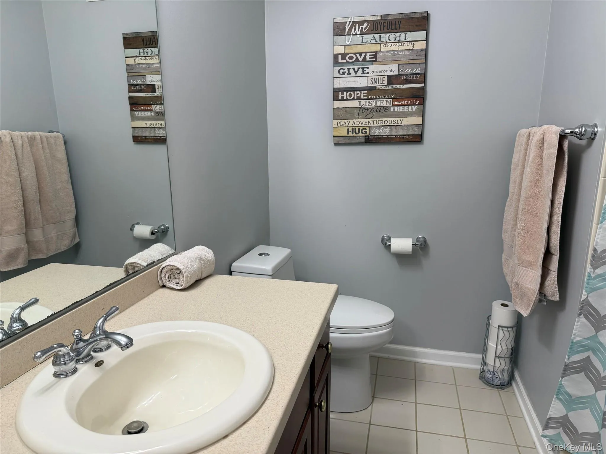 Bathroom with vanity and light tile patterned floors Bathroom with vanity and light tile patterned floors