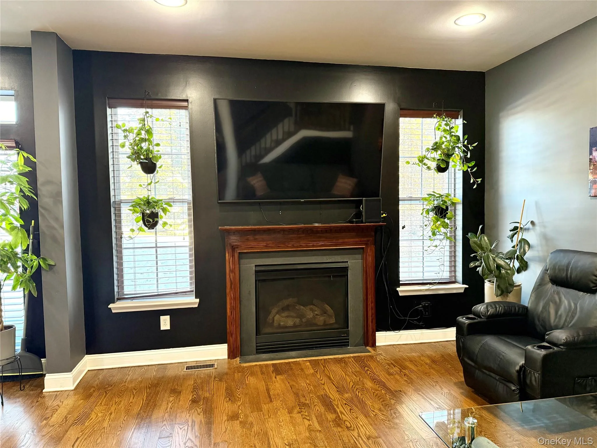 Living room with a fireplace and wood finished floors Living room with a fireplace and wood finished floors