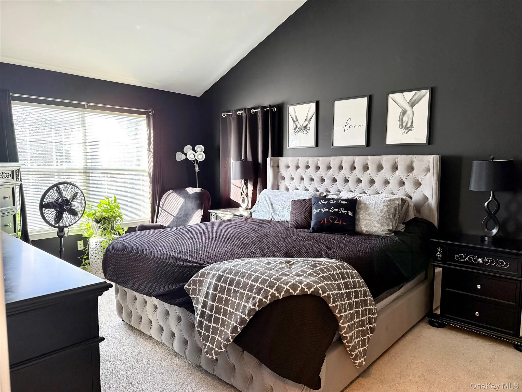 Bedroom featuring lofted ceiling and light carpet Bedroom featuring lofted ceiling and light carpet