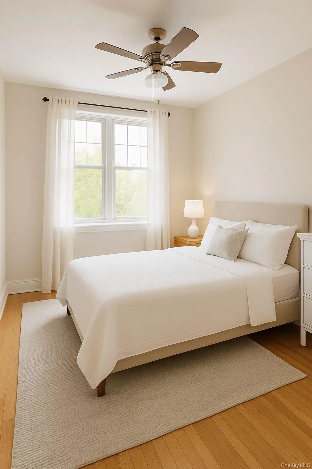 Bedroom featuring light wood-style floors and a ceiling fan Bedroom featuring light wood-style floors and a ceiling fan