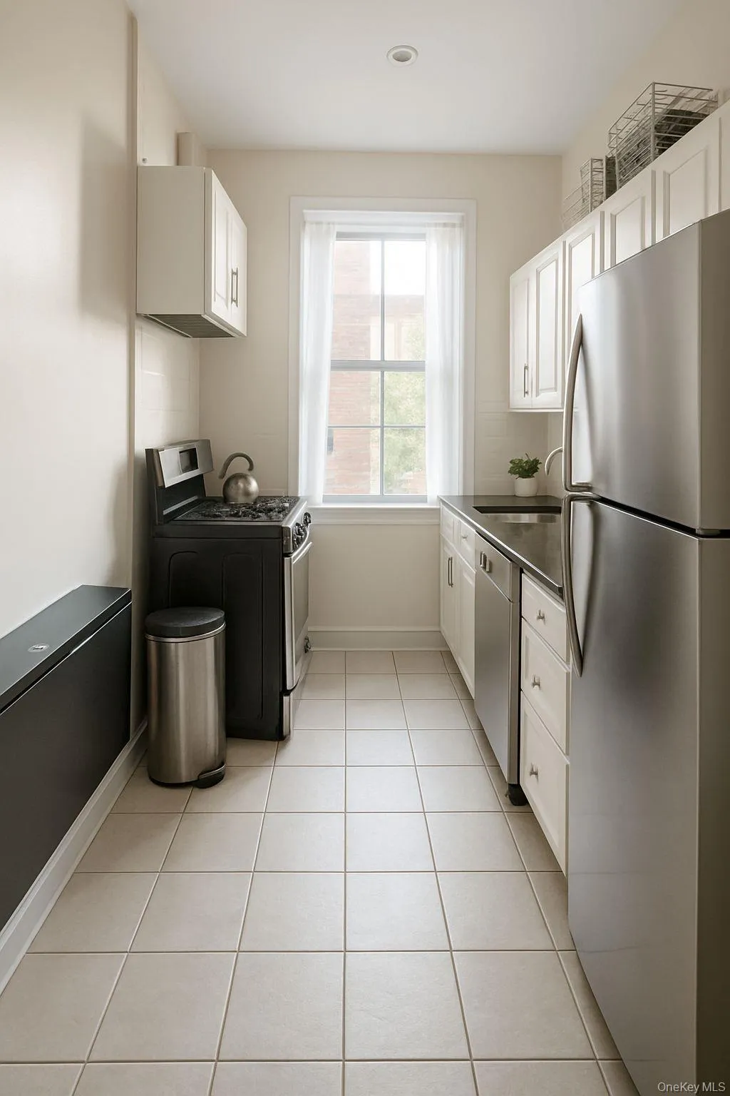Kitchen featuring stainless steel appliances, white cabinets, dark countertops, light tile patterned floors, and recessed lighting Kitchen featuring stainless steel appliances, white cabinets, dark countertops, light tile patterned floors, and recessed lighting