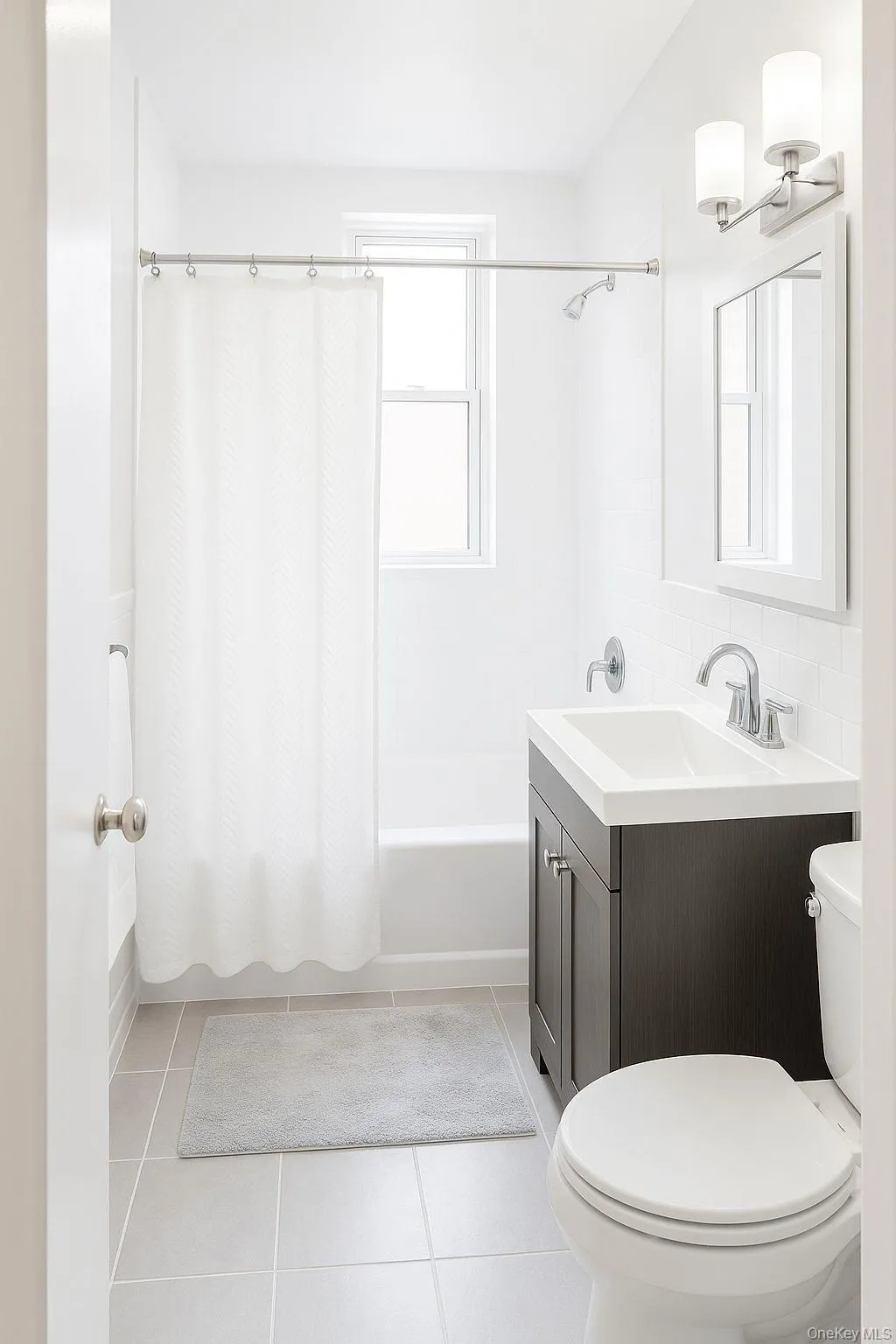 Full bathroom with light tile patterned flooring, shower / tub combo, and vanity Full bathroom with light tile patterned flooring, shower / tub combo, and vanity