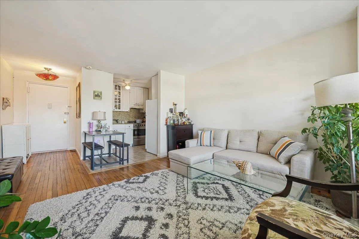 Living area with light wood-style floors and ceiling fan Living area with light wood-style floors and ceiling fan