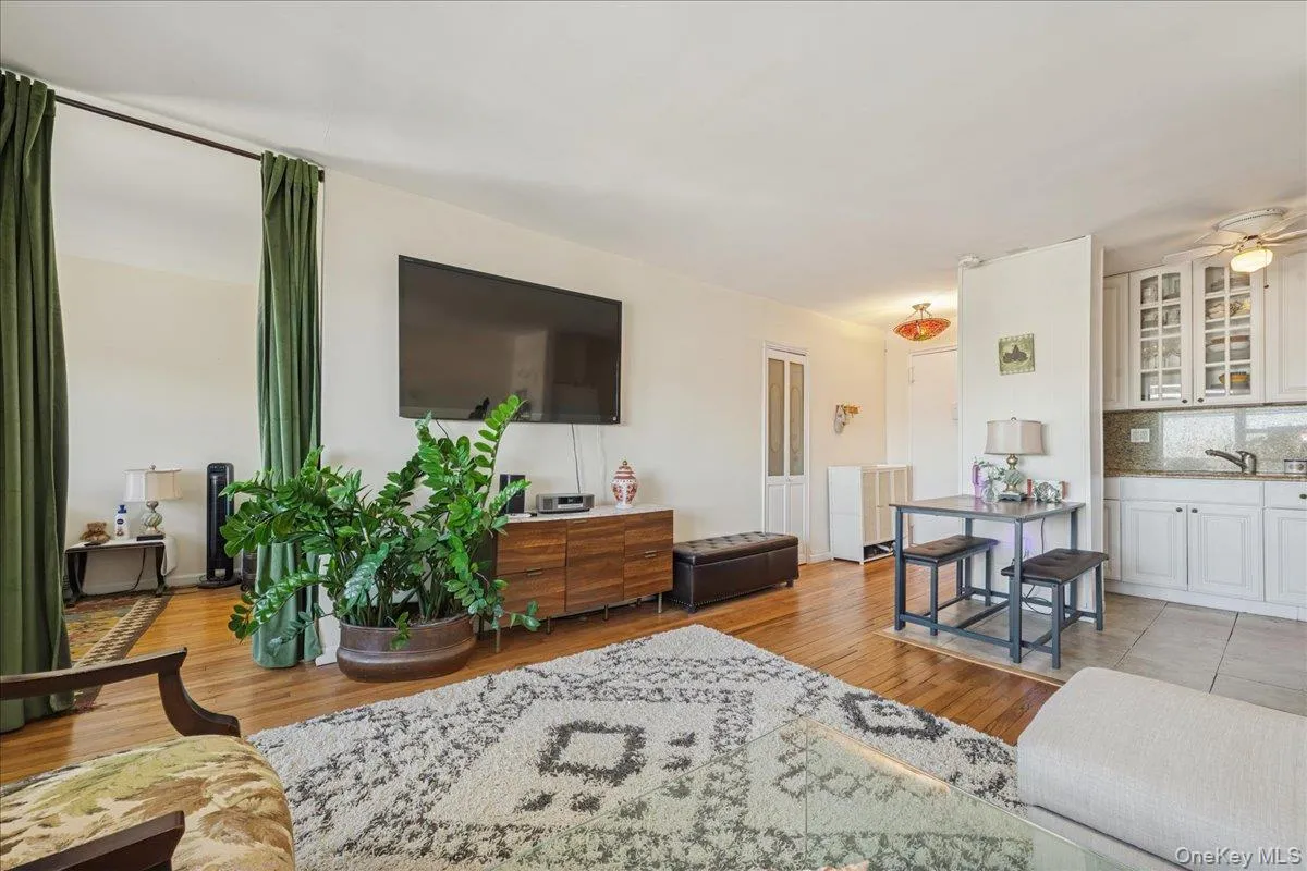 Living room with light wood-style flooring and ceiling fan Living room with light wood-style flooring and ceiling fan