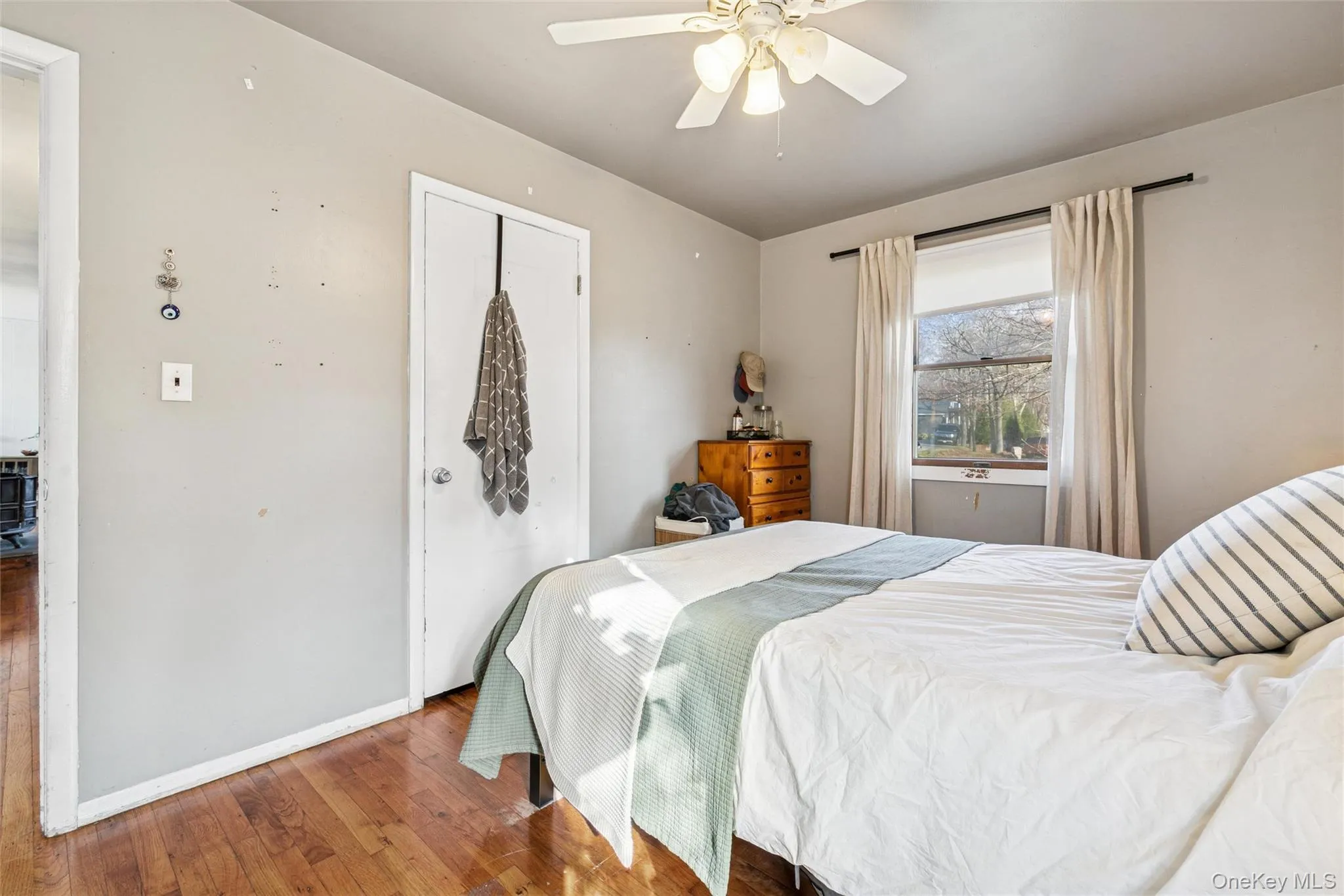 Bedroom featuring hardwood / wood-style flooring and ceiling fan Bedroom featuring hardwood / wood-style flooring and ceiling fan