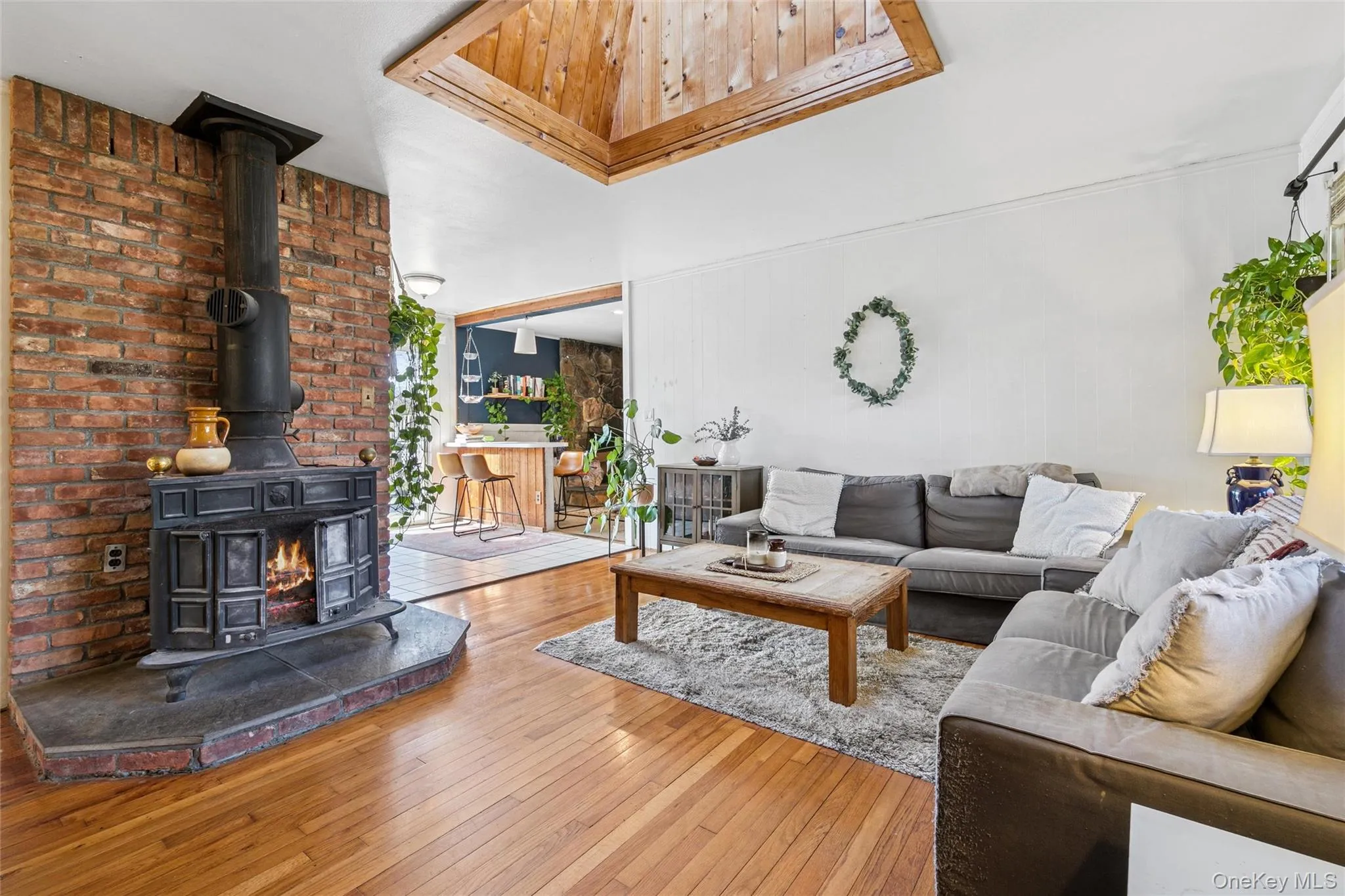 Living area with a wood stove and hardwood / wood-style flooring Living area with a wood stove and hardwood / wood-style flooring