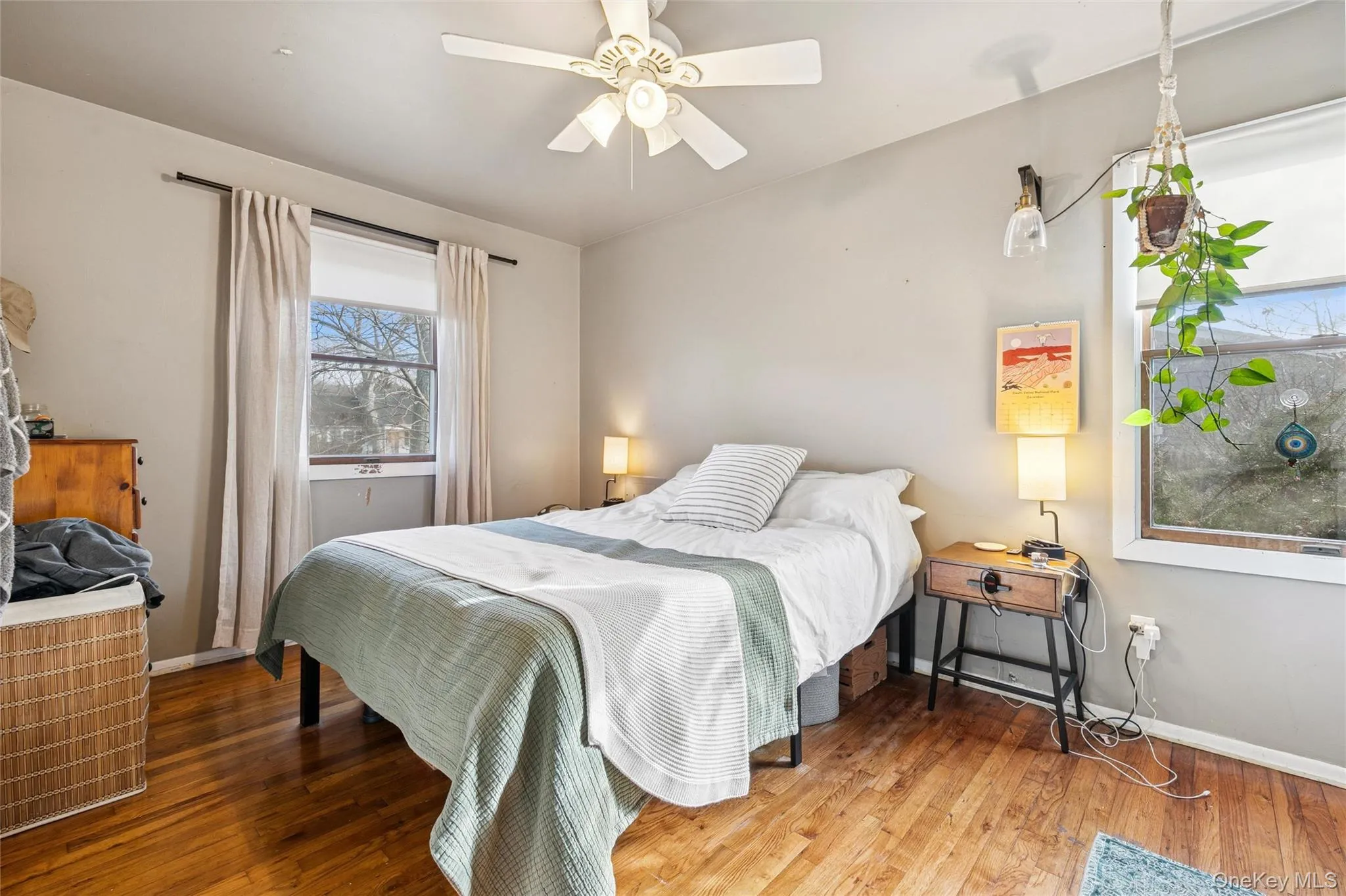 Bedroom featuring hardwood / wood-style floors and ceiling fan Bedroom featuring hardwood / wood-style floors and ceiling fan