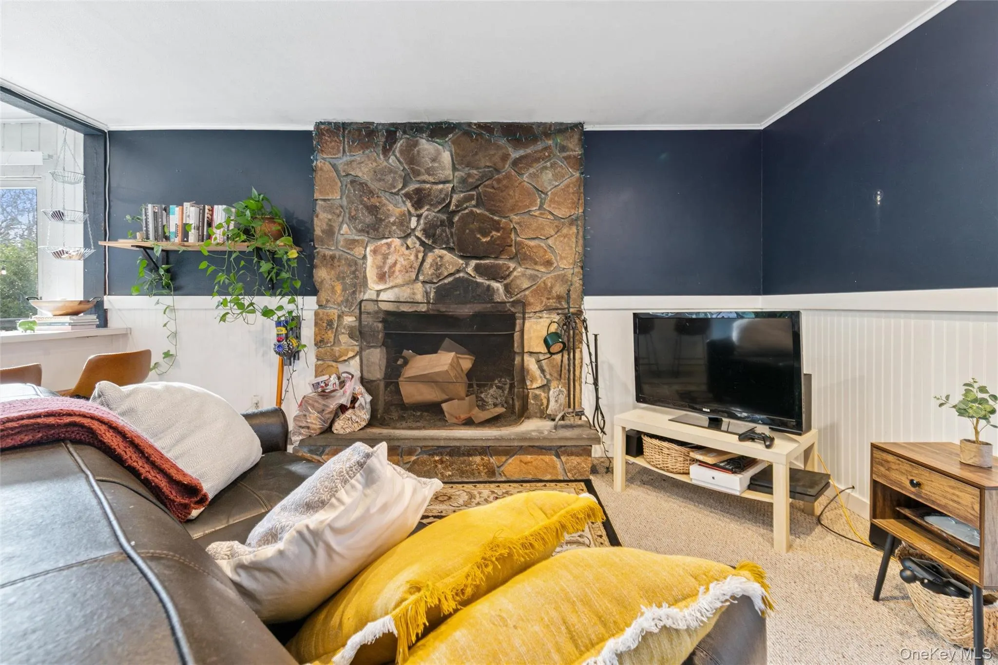 Living room featuring carpet flooring, a fireplace, and crown molding Living room featuring carpet flooring, a fireplace, and crown molding