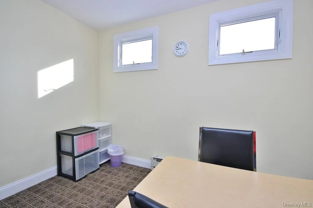 Home office with baseboards and a baseboard heating unit Home office with baseboards and a baseboard heating unit