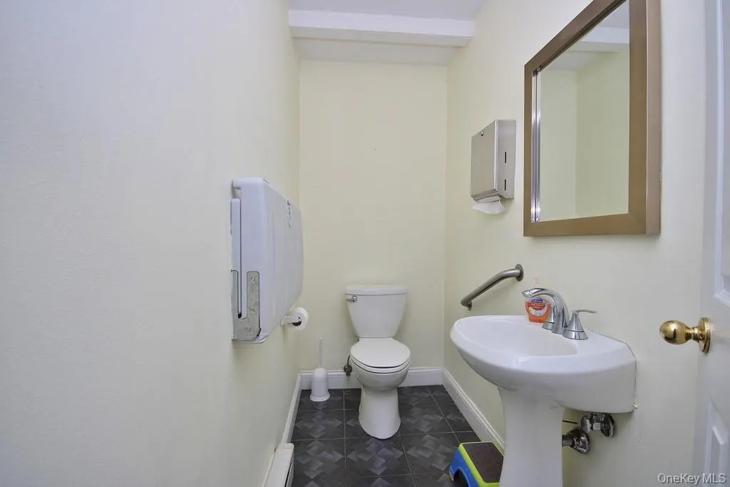 Bathroom featuring toilet and tile patterned floors Bathroom featuring toilet and tile patterned floors