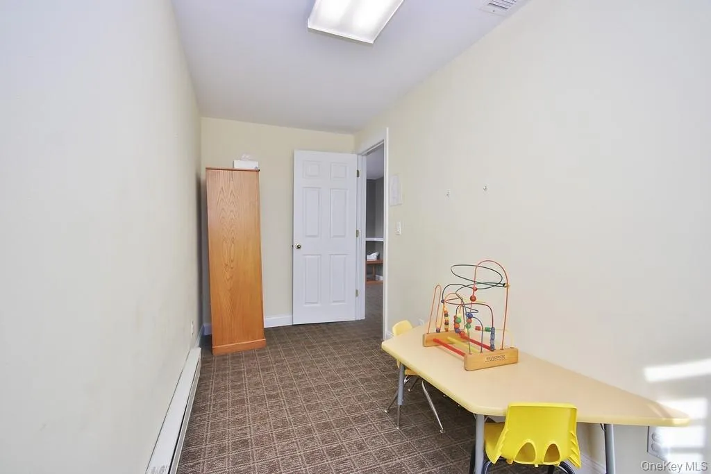 Hallway with a baseboard radiator and baseboards Hallway with a baseboard radiator and baseboards