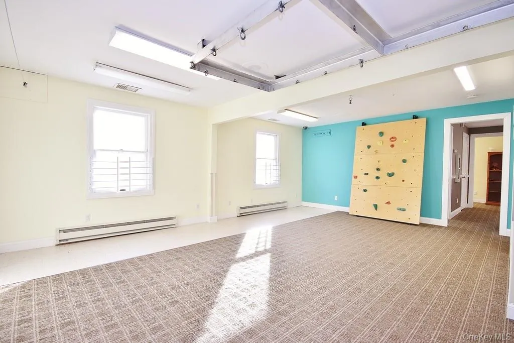 Spare room featuring baseboard heating and a baseboard heating unit Spare room featuring baseboard heating and a baseboard heating unit