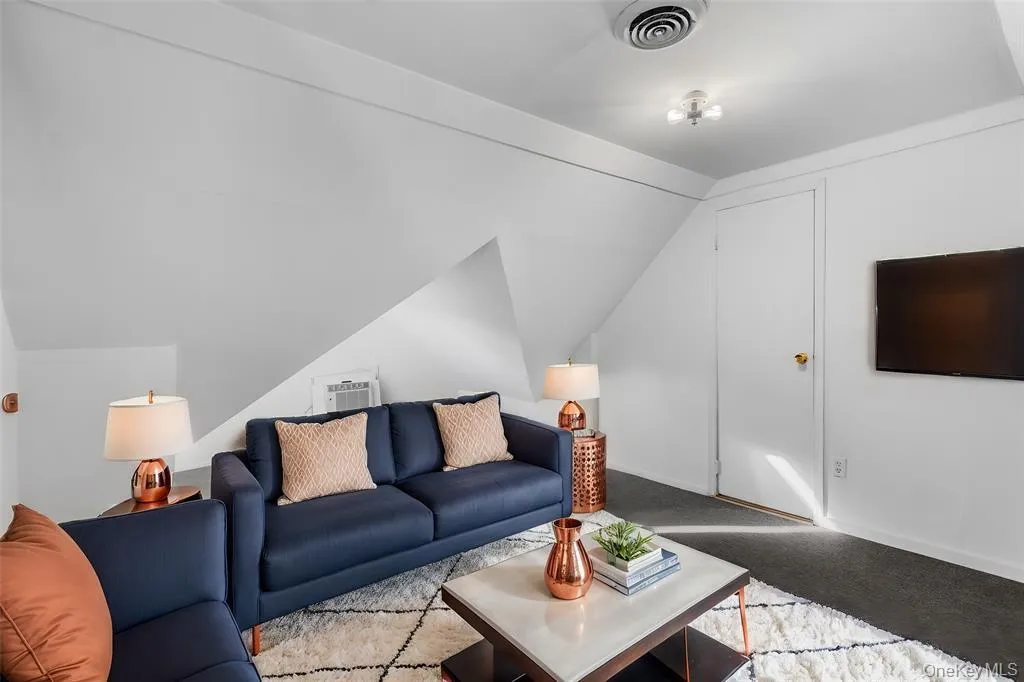 Virtually Staged - Carpeted living room featuring lofted ceiling Virtually Staged - Carpeted living room featuring lofted ceiling