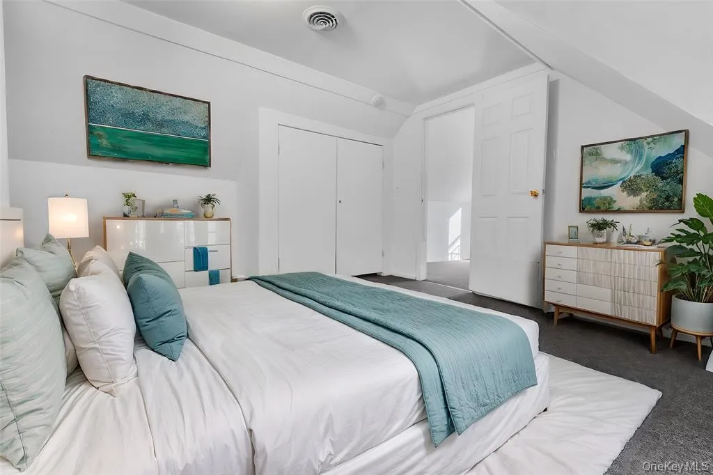 Virtually Staged - Bedroom featuring dark colored carpet, a closet, and vaulted ceiling Virtually Staged - Bedroom featuring dark colored carpet, a closet, and vaulted ceiling
