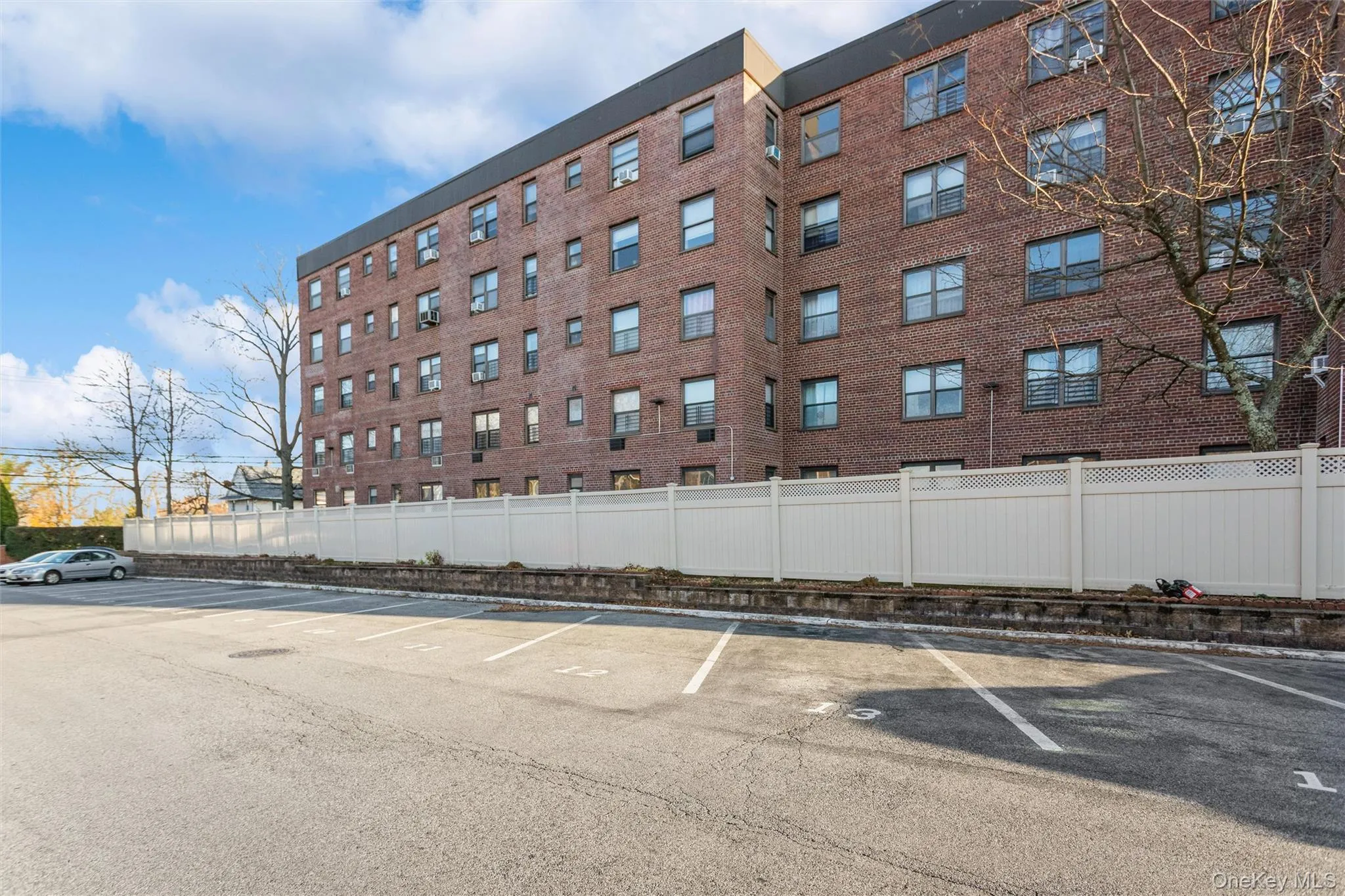 View of apartment building / complex featuring uncovered parking View of apartment building / complex featuring uncovered parking