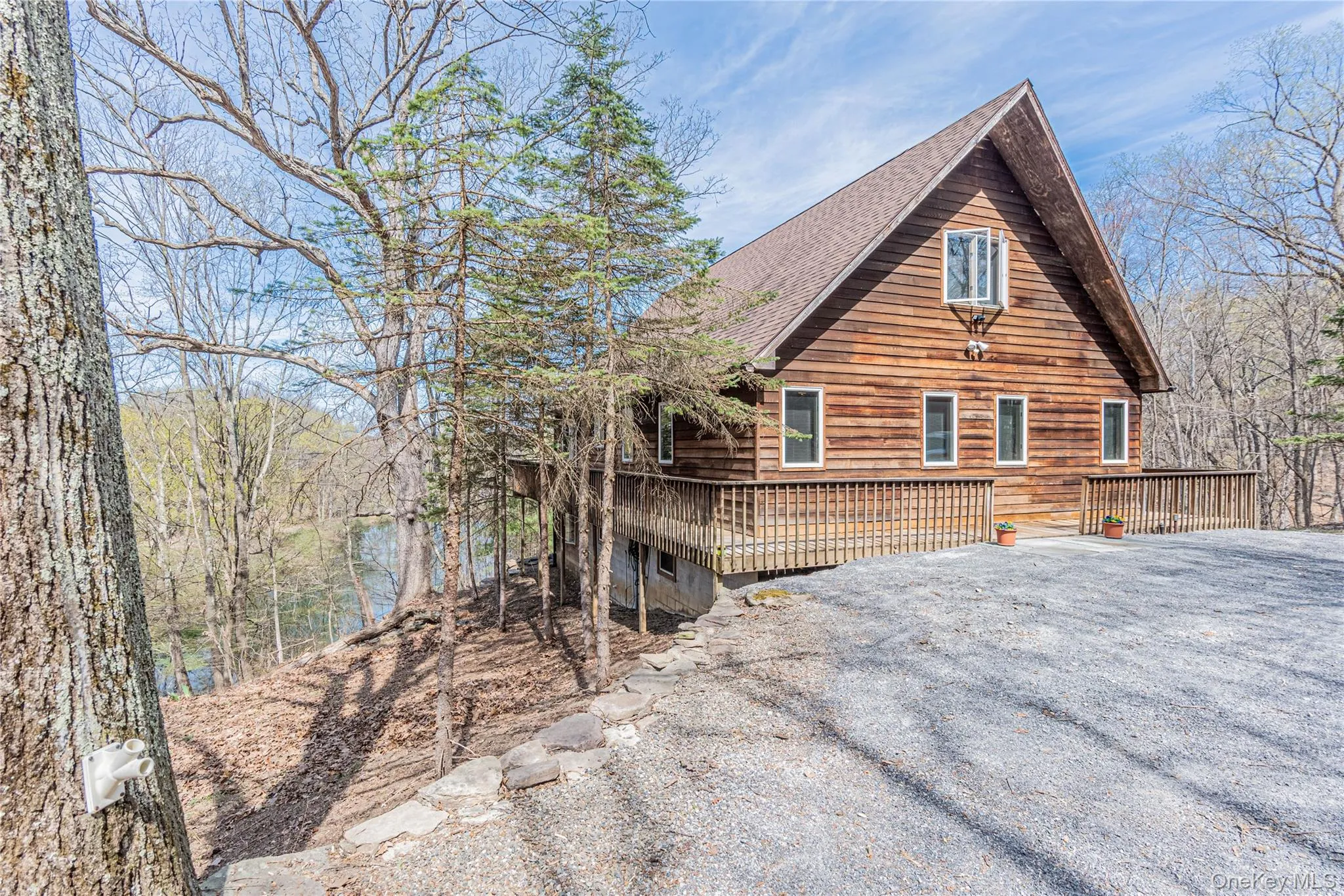 View of home's exterior with roof with shingles and a deck View of home's exterior with roof with shingles and a deck