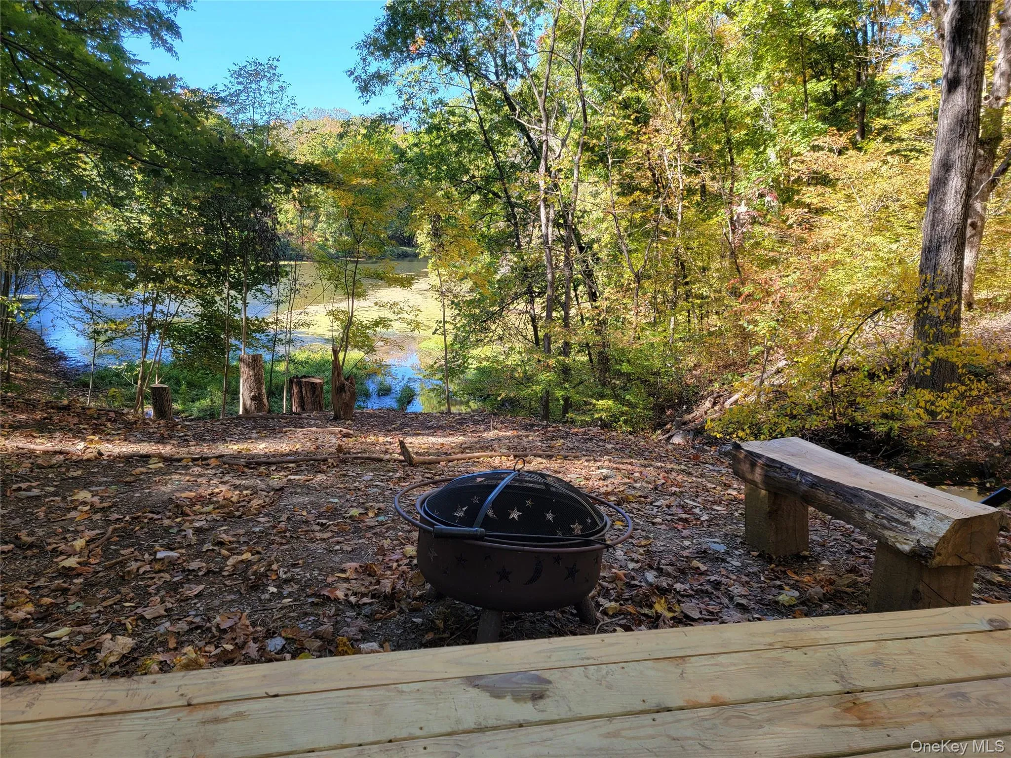 View of yard featuring a fire pit View of yard featuring a fire pit