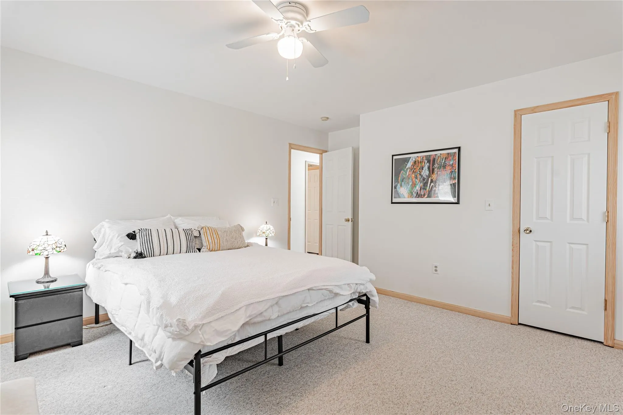Bedroom with light colored carpet and ceiling fan Bedroom with light colored carpet and ceiling fan