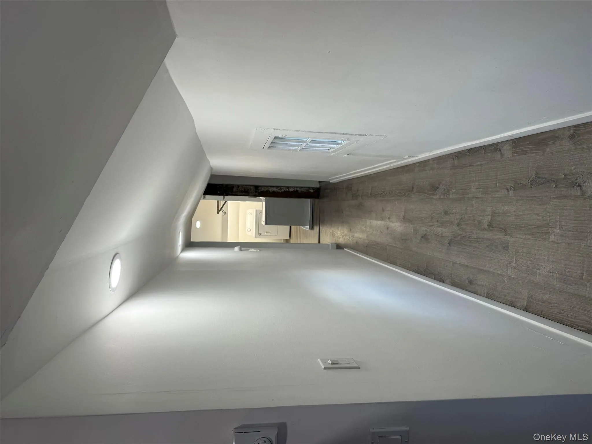 Hall featuring dark wood finished floors and washer / clothes dryer Hall featuring dark wood finished floors and washer / clothes dryer