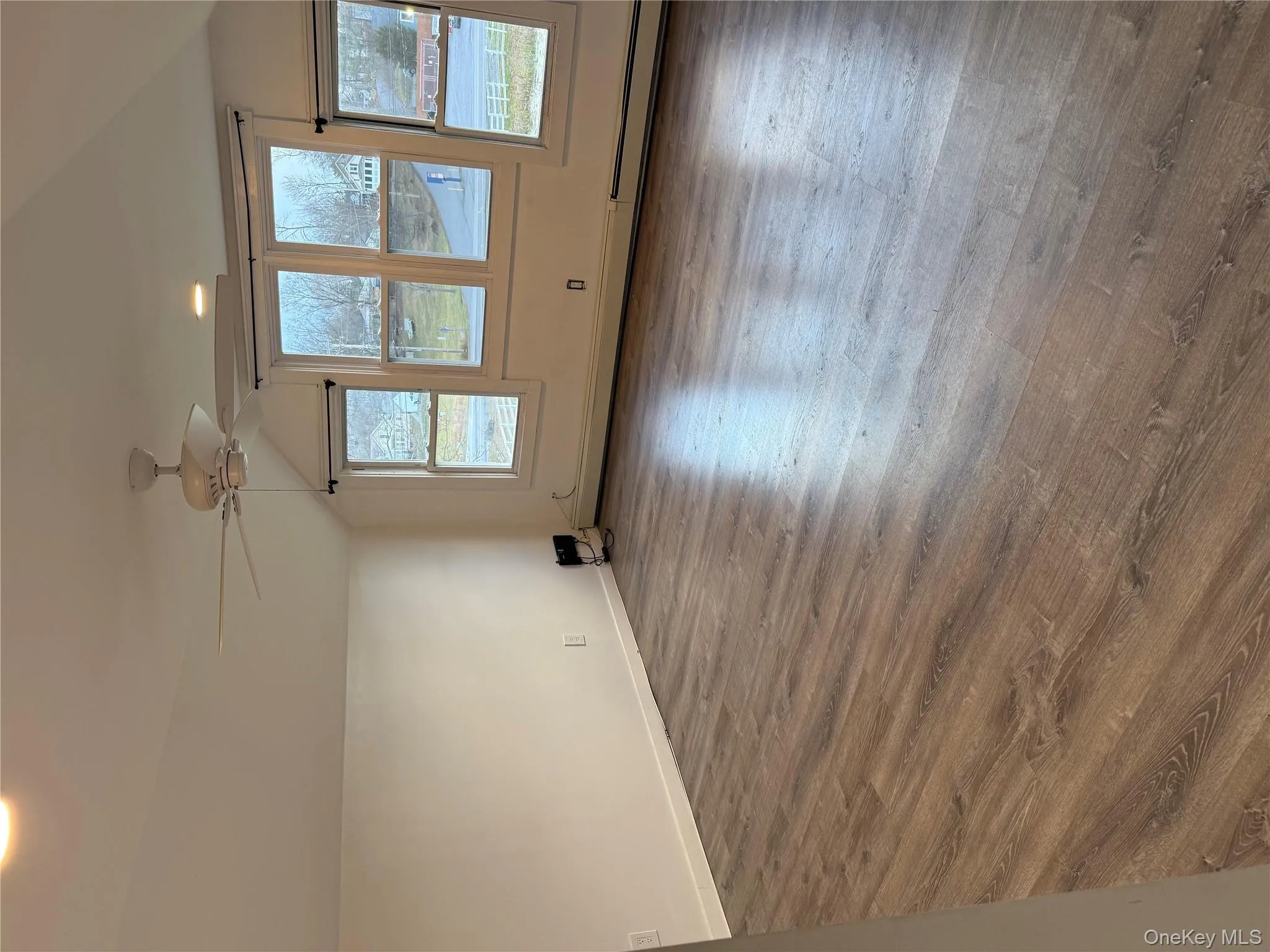 Additional living space with vaulted ceiling, dark wood-type flooring, recessed lighting, baseboard heating, and a ceiling fan Additional living space with vaulted ceiling, dark wood-type flooring, recessed lighting, baseboard heating, and a ceiling fan