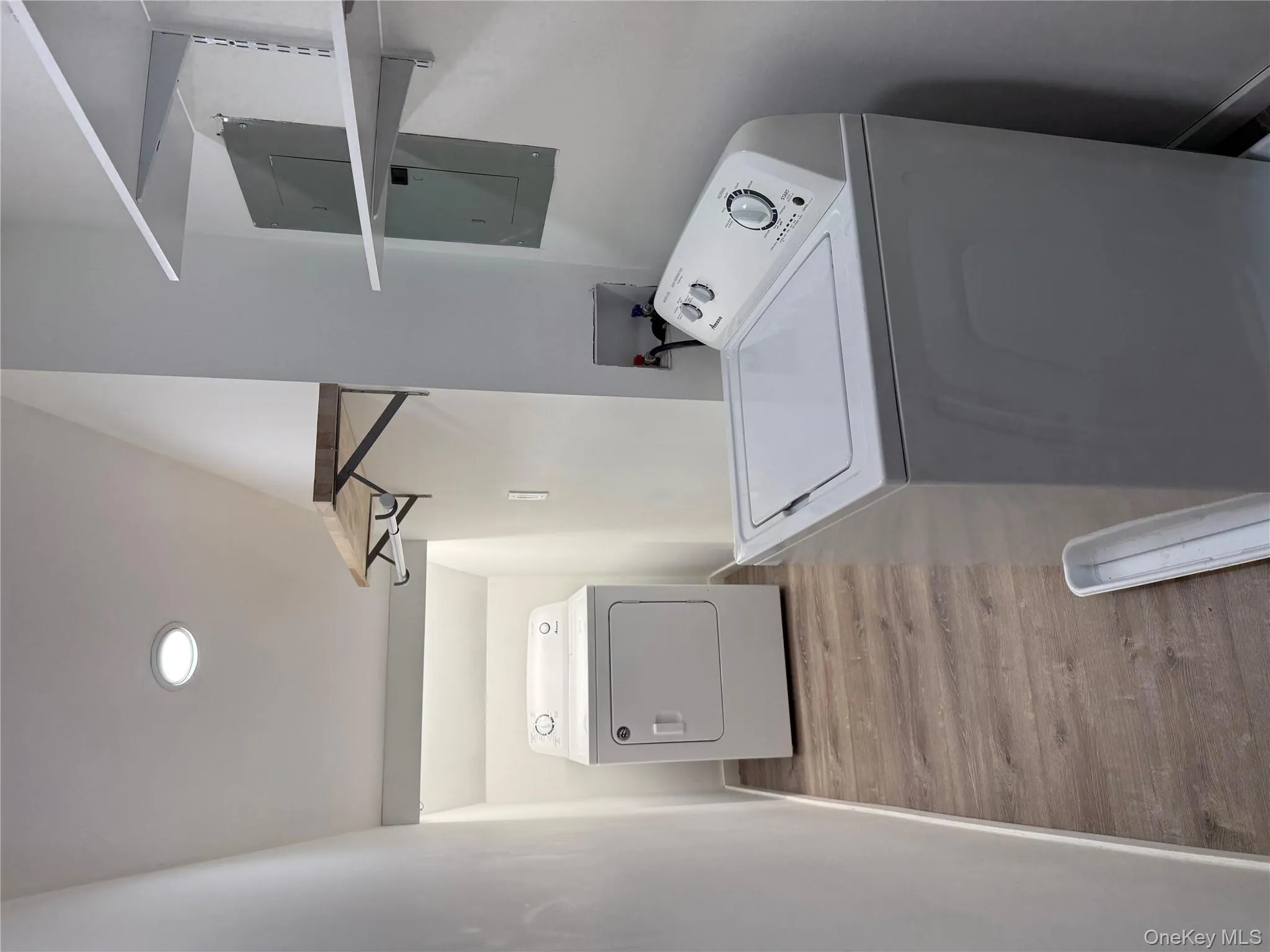 Laundry area featuring electric panel, light wood finished floors, recessed lighting, and independent washer and dryer Laundry area featuring electric panel, light wood finished floors, recessed lighting, and independent washer and dryer