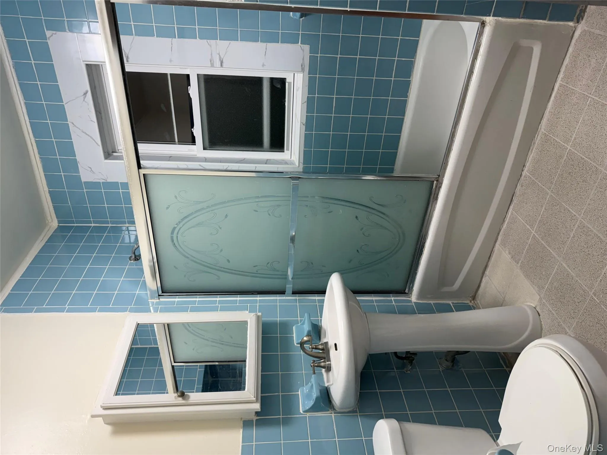 Full bathroom featuring combined bath / shower with glass door, tile walls, and crown molding Full bathroom featuring combined bath / shower with glass door, tile walls, and crown molding
