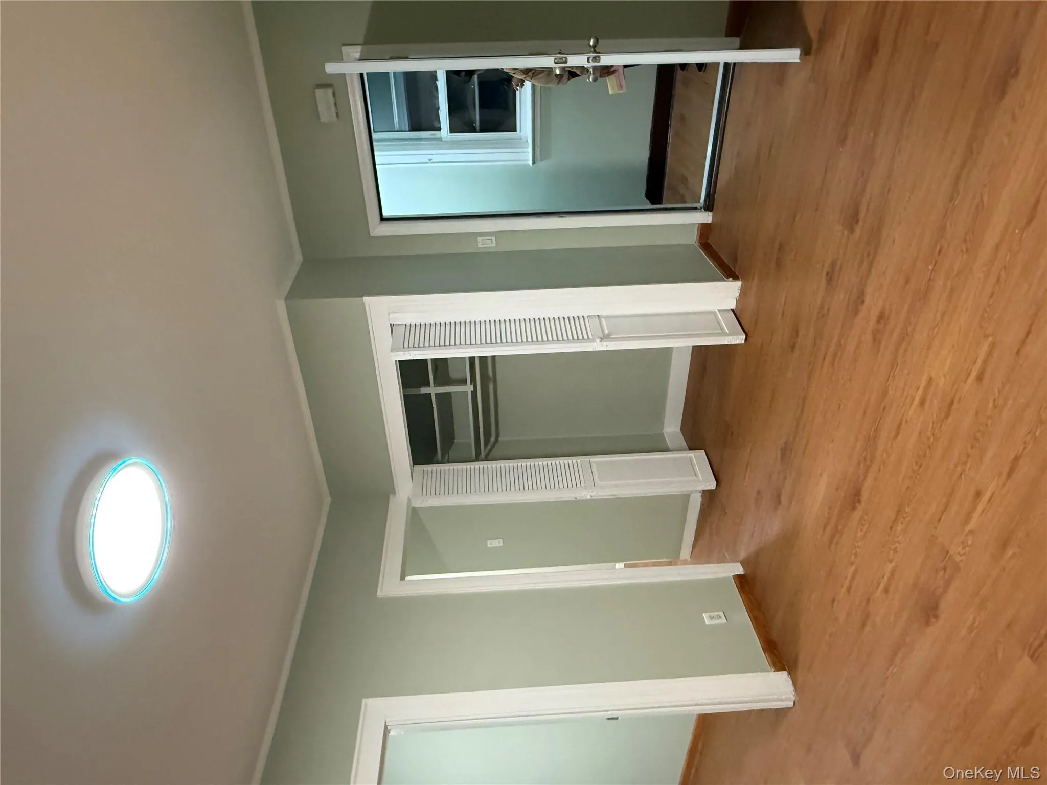 Unfurnished bedroom featuring light wood-style floors, crown molding, and two closets Unfurnished bedroom featuring light wood-style floors, crown molding, and two closets