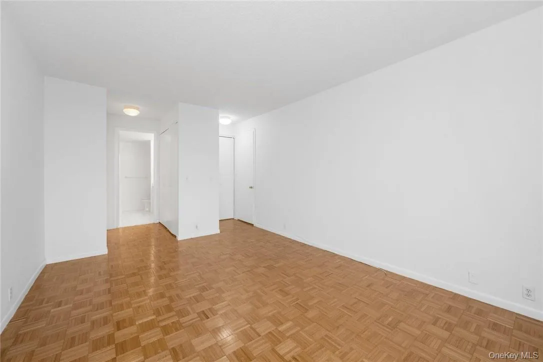 Primary bedroom facing full bathroom and multiple closets Primary bedroom facing full bathroom and multiple closets