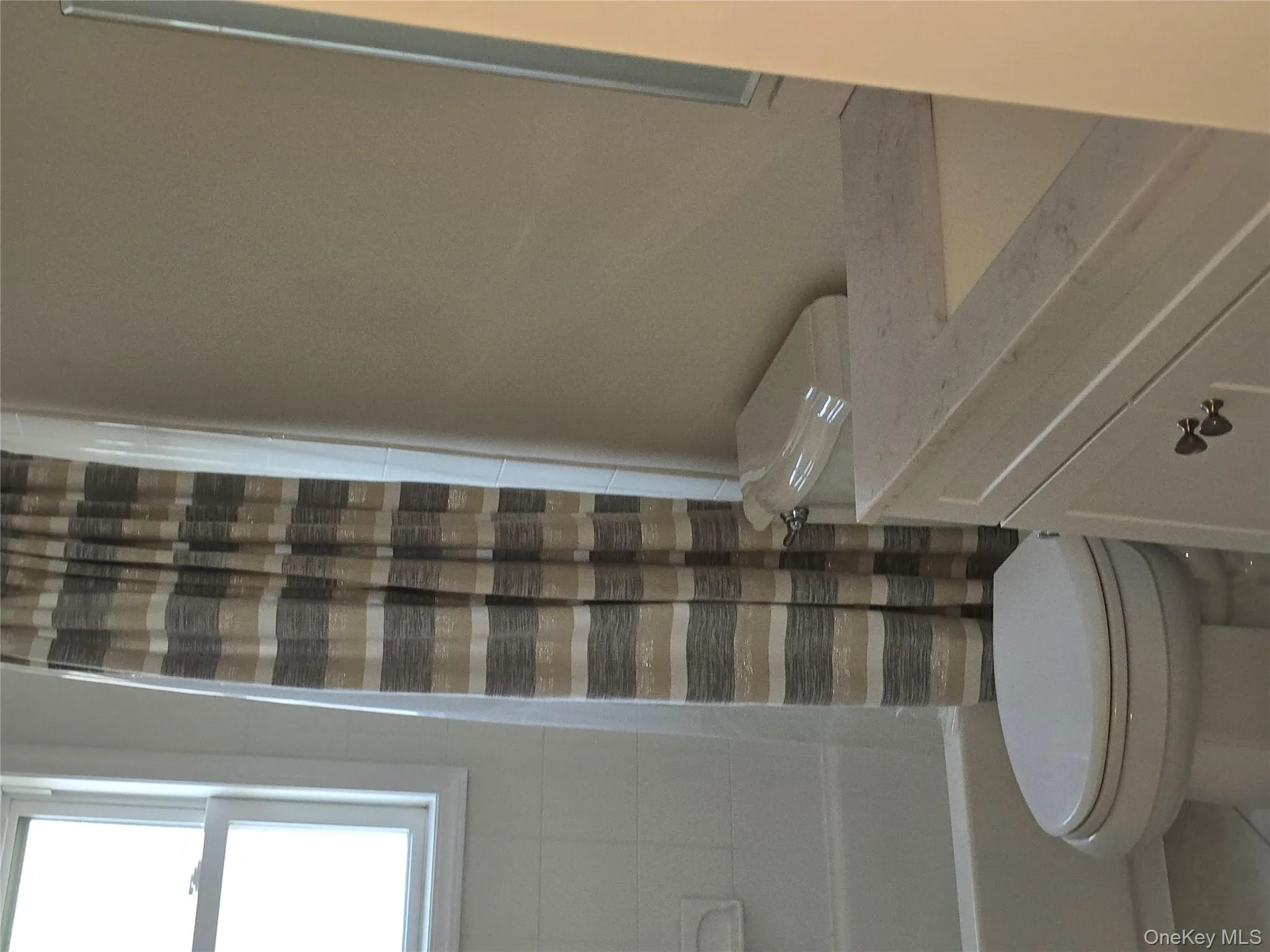 Bathroom with vanity, shower / bath combination with curtain, and tile patterned floors Bathroom with vanity, shower / bath combination with curtain, and tile patterned floors