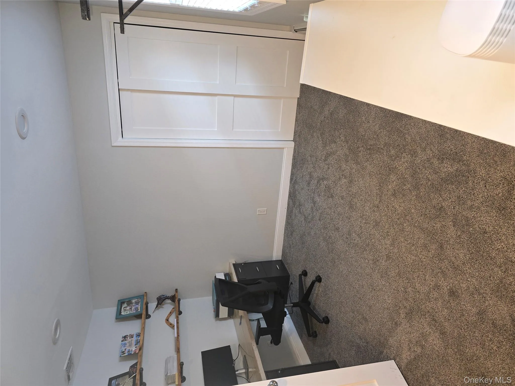 Office space featuring dark colored carpet and baseboards Office space featuring dark colored carpet and baseboards