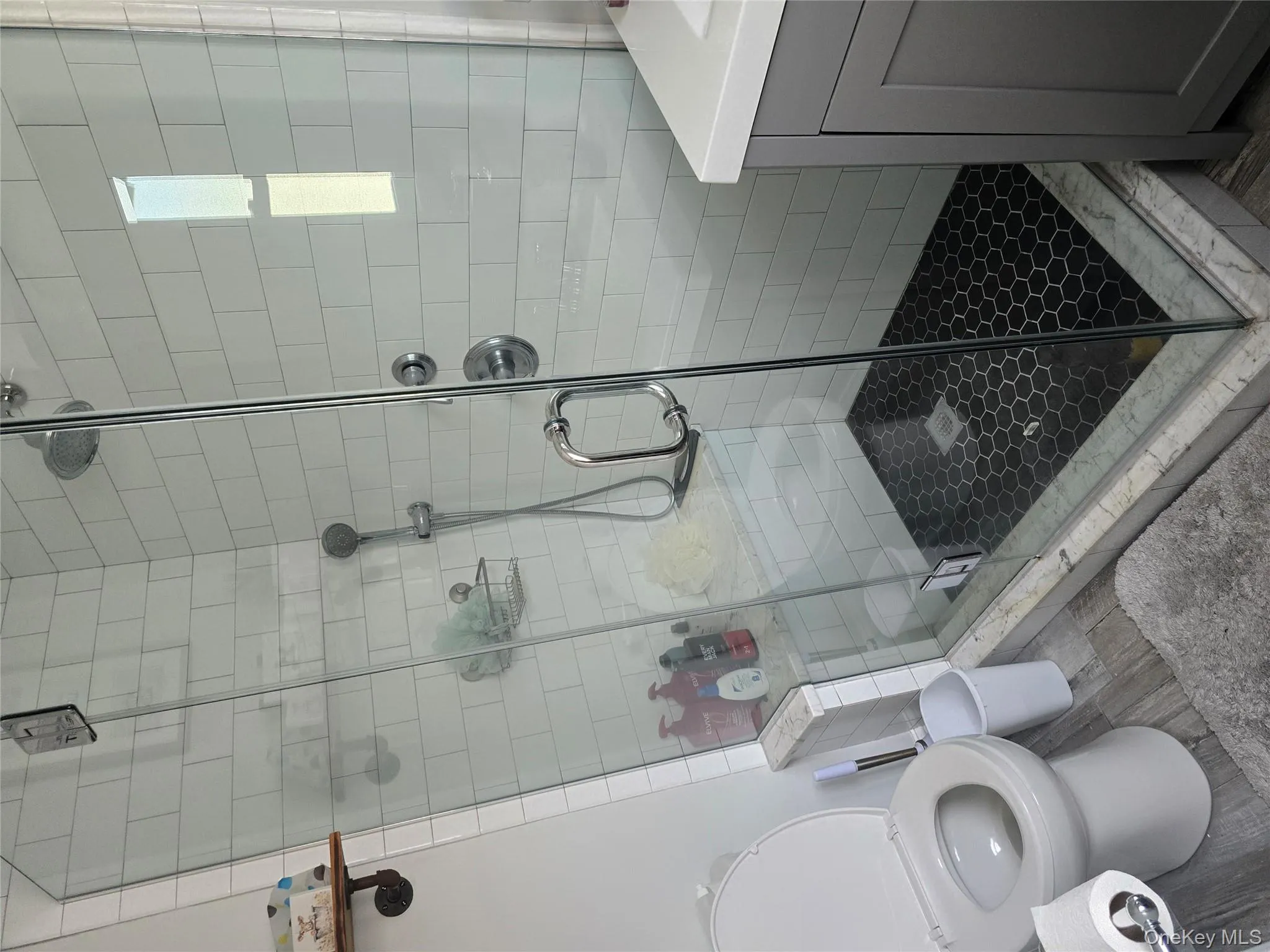 Bathroom featuring vanity and a stall shower Bathroom featuring vanity and a stall shower